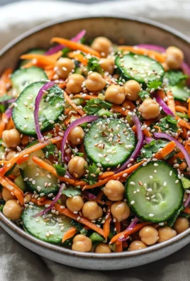 Asian cucumber and chickpea slaw with sesame dressing in a bowl