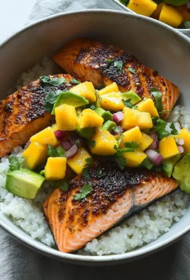 BBQ salmon bowl with mango avocado salsa on a wooden table