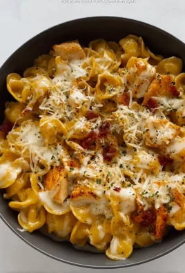 Delicious cheesy chicken pasta served in a bowl with herbs and spices