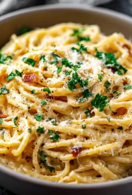 A bowl of cheesy garlic parmesan spaghetti garnished with parsley