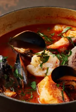 Bowls of delicious Cioppino seafood stew with fresh ingredients.