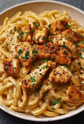 Delicious creamy Cajun Chicken Pasta with spices and herbs in a bowl
