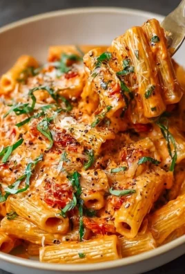 Creamy tomato garlic pasta dish with fresh ingredients and herbs