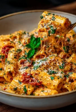 Creamy tomato garlic pasta bowl topped with fresh basil and parmesan cheese.