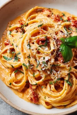 Delicious creamy tomato pasta garnished with fresh basil and parmesan cheese