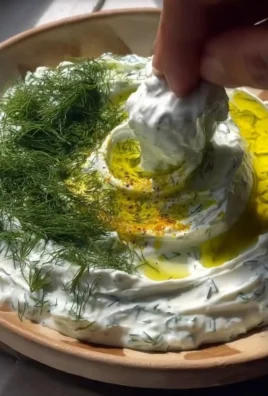 Bowl of easy Greek Tzatziki with cucumber and herbs