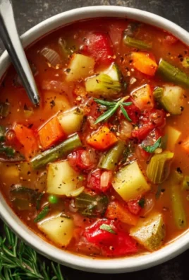 bowl of easy vegetable soup with fresh vegetables and herbs