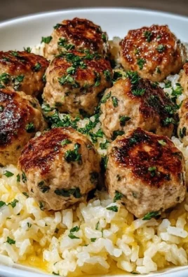 Plate of Greek Turkey Meatballs with Lemon Herb Rice garnished with fresh herbs