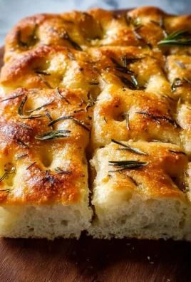 Freshly baked homemade focaccia bread with herbs and olive oil