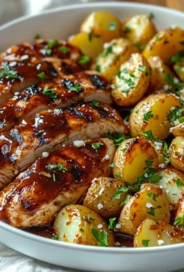 Honey BBQ Chicken served with Garlic Parmesan Potatoes on a dinner plate