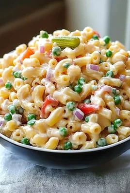 Delicious macaroni salad served in a bowl with fresh vegetables