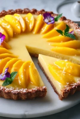 Delicious Mango Curd Tart with a buttery crust and fresh mango topping