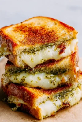 Mouthwatering Pesto Grilled Cheese sandwich with fresh basil and melted cheese.