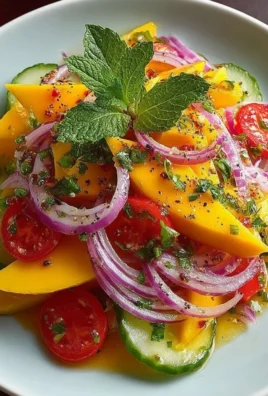 Refreshing mango salad topped with lime dressing in a bowl