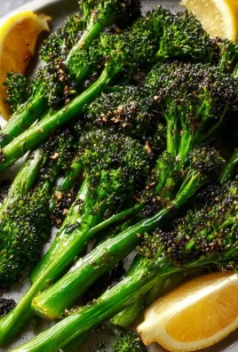 Fresh roasted broccolini served in a bowl with seasoning.