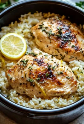 Slow cooker lemon herb chicken and rice with fresh herbs and lemon slice