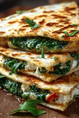 Golden brown spinach feta quesadillas sliced and served with salsa.