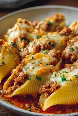 Delicious stuffed pasta shells filled with cheese and herbs, ready for baking.