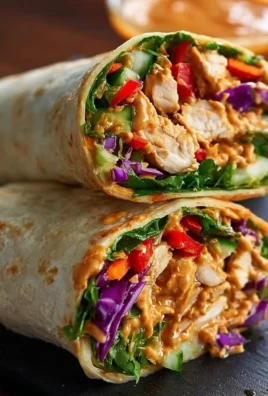 Thai Peanut Chicken Wraps filled with fresh vegetables and creamy peanut sauce