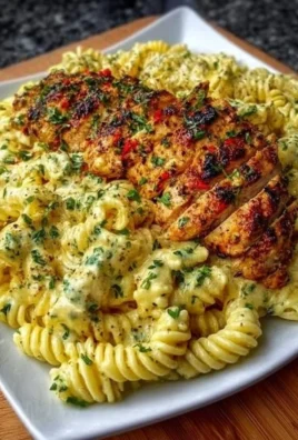 Creamy garlic parmesan chicken pasta served in a bowl with parmesan cheese sprinkled on top.