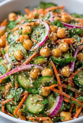 Asian cucumber and chickpea slaw with sesame dressing in a bowl
