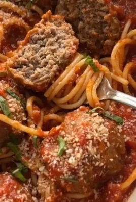 Baked Italian meatballs served with tomato sauce and herbs