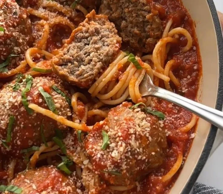 Baked Italian meatballs served with tomato sauce and herbs