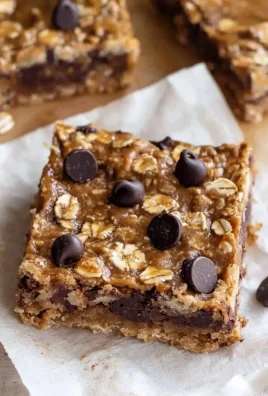 Homemade banana oatmeal bars on a wooden table, healthy snack option.