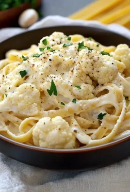 Bowl of creamy Cauliflower Alfredo without heavy cream, garnished with parsley.