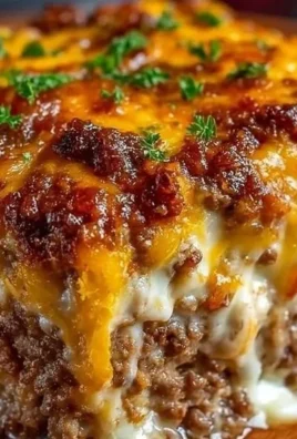 Delicious Cheesy Meatloaf Casserole garnished with herbs in a baking dish