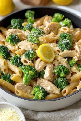 Creamy Chicken Broccoli Pasta topped with lemon sauce and fresh herbs