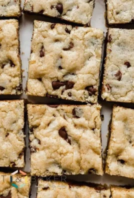 Delicious homemade chocolate chip cookie bars on a wooden table