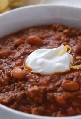 Bowl of classic homemade chili topped with fresh herbs