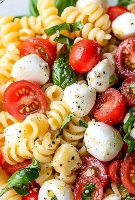 Colorful Caprese pasta salad with tomatoes, mozzarella, and basil