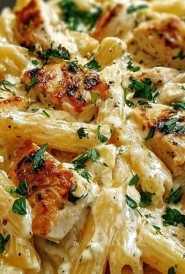 Creamy ricotta chicken pasta served in a bowl with fresh herbs.
