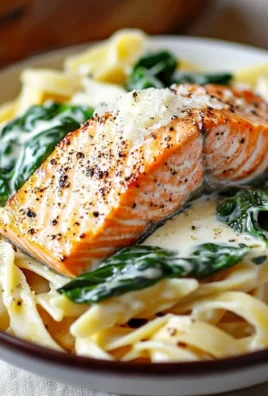 Creamy salmon pasta dish served in a bowl with fresh herbs on top