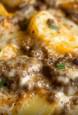 Delicious crockpot hamburger potato casserole with melting cheese and fresh herbs