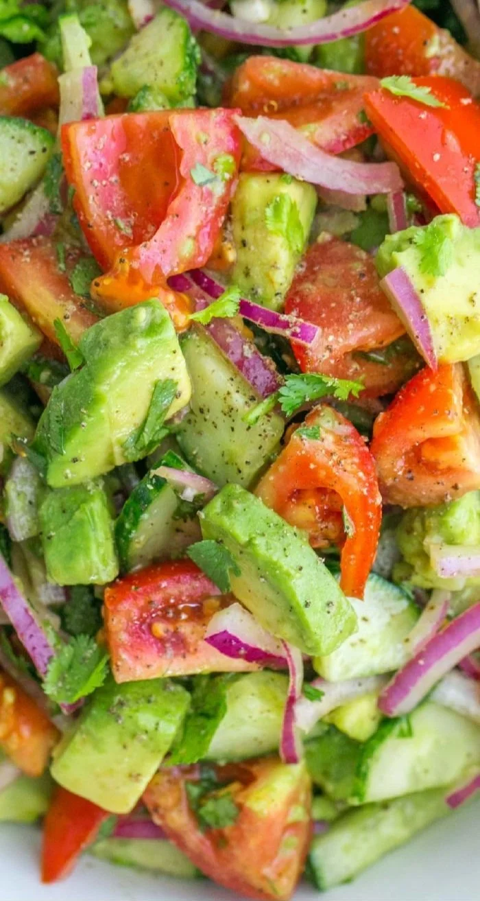 Fresh Cucumber Tomato Avocado Salad with colorful vegetables and healthy ingredients
