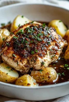 Delicious Garlic Herb Chicken garnished with fresh herbs and spices.