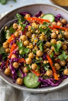 Healthy Thai-inspired chickpea salad with colorful vegetables and herbs.