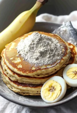 Plate of fluffy high protein pancakes topped with fresh berries and syrup