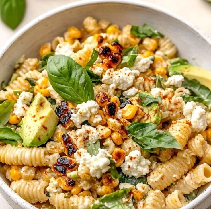 Bowl of Juicy Street Corn Pasta Salad with colorful toppings and fresh ingredients
