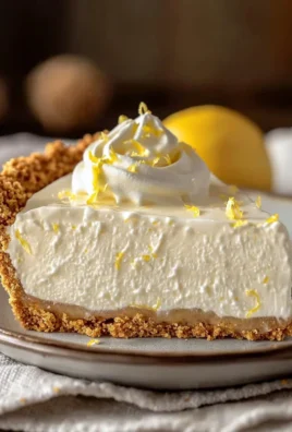 No-bake lemon icebox pie topped with whipped cream and lemon slices