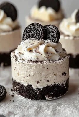 No-Bake Oreo Cheesecakes topped with crushed Oreos on a white plate