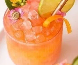 Colorful Pineapple Mango Rum Punch in a glass with tropical fruits