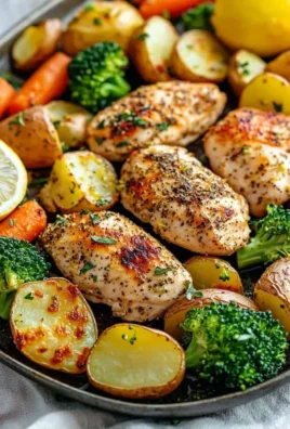 Delicious sheet pan lemon herb chicken with colorful vegetables ready to serve.