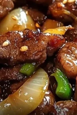 Sizzling Chinese Pepper Steak with Onions served on a plate