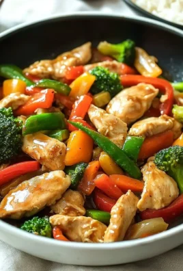 Stir fry chicken with colorful vegetables in a skillet