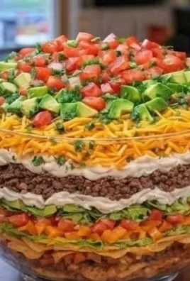 Ultimate seven layer taco salad with fresh ingredients and vibrant colors