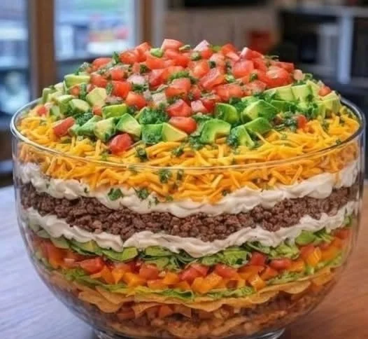 Ultimate seven layer taco salad with fresh ingredients and vibrant colors